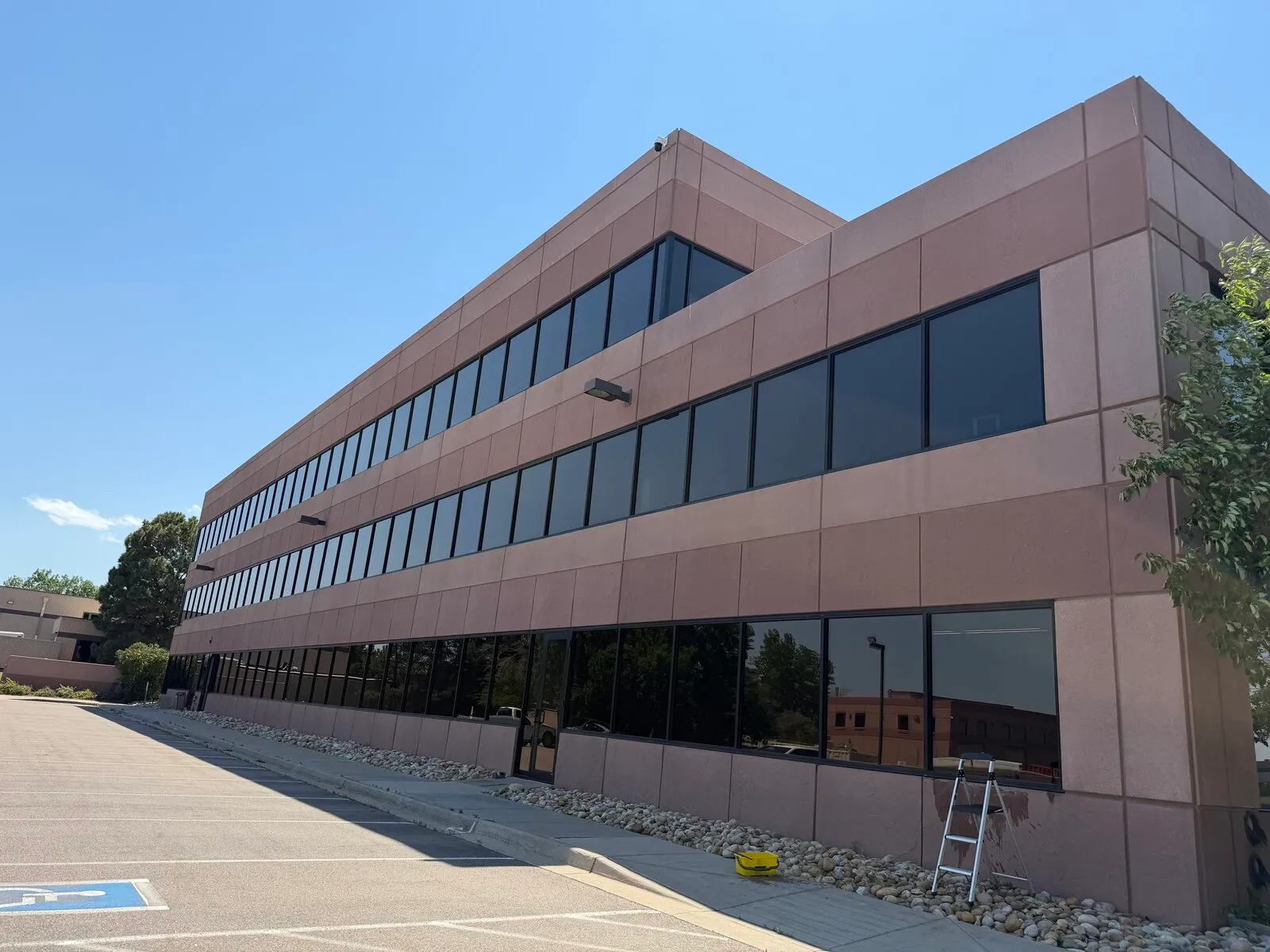 Three-story commercial office building with bands of tinted glass windows