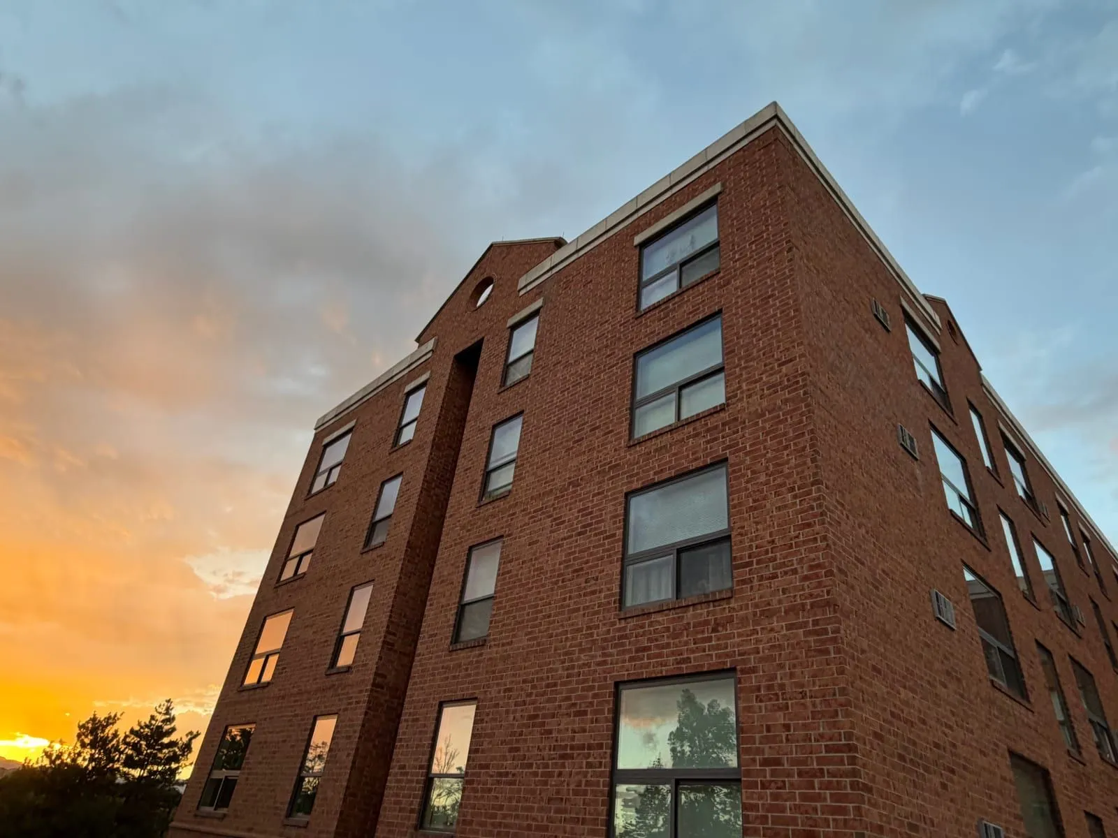 Multi-story brick commercial building in Denver after exterior window cleaning at sunset