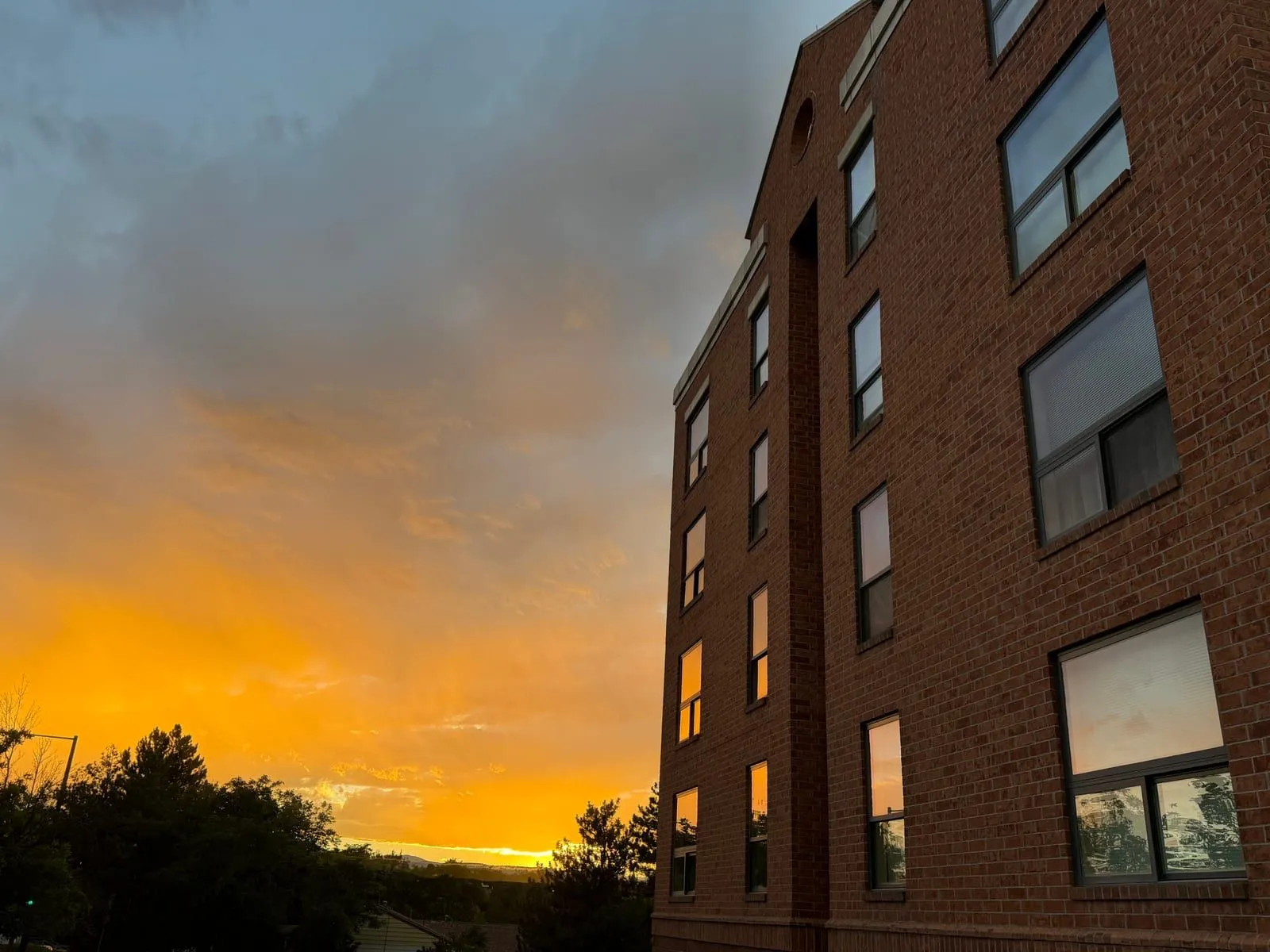 Sunset reflected in windows on a brick commercial building after window cleaning in Denver