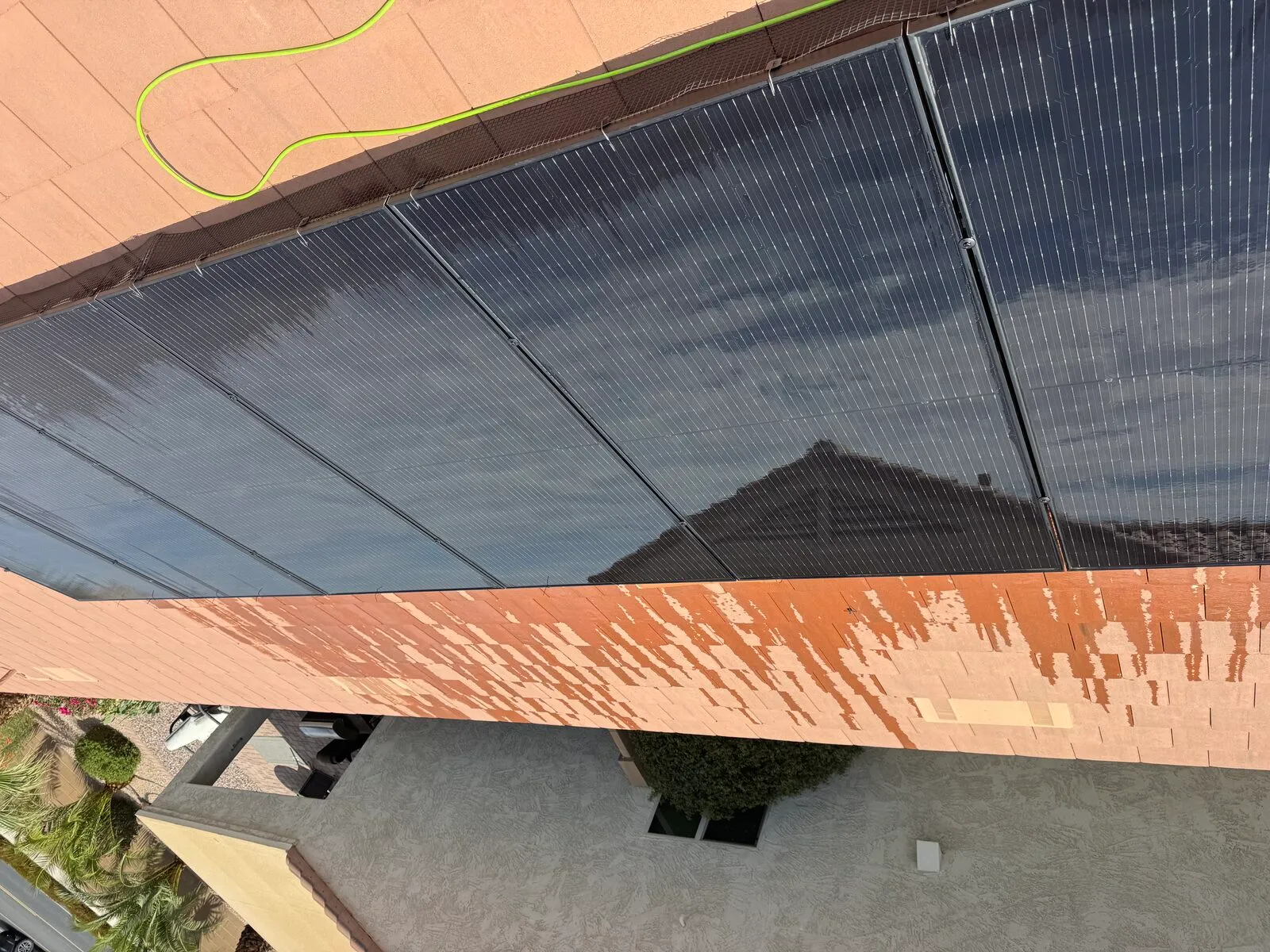 Close view of cleaned solar panels reflecting clouds