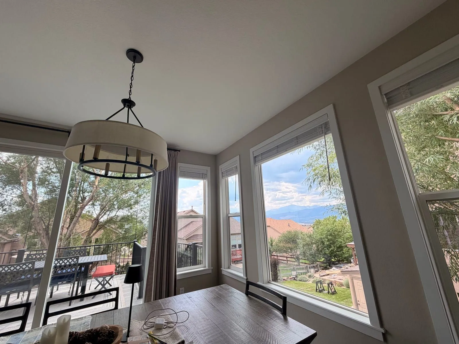 Clean dining-area windows in a Denver home with a clear view of trees and mountains