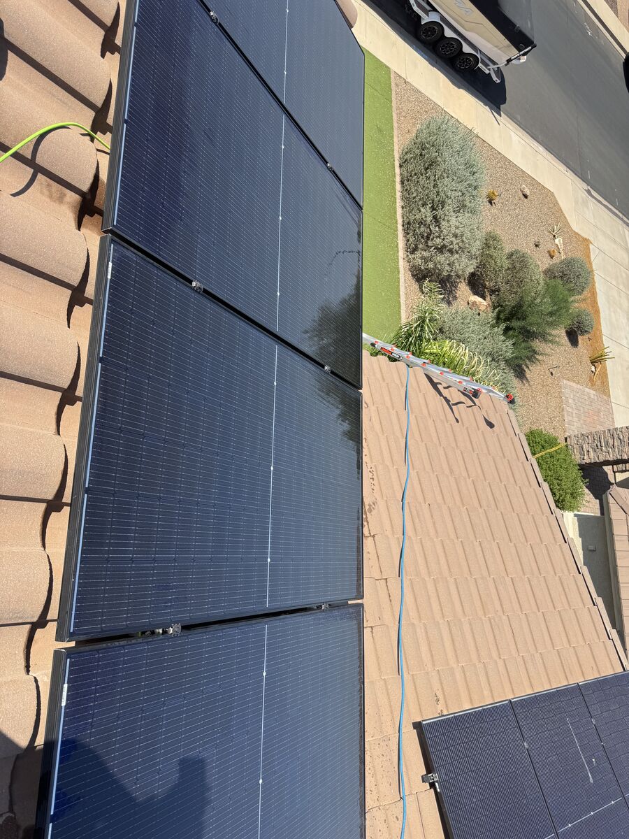 Freshly cleaned rooftop solar array reflecting the sky